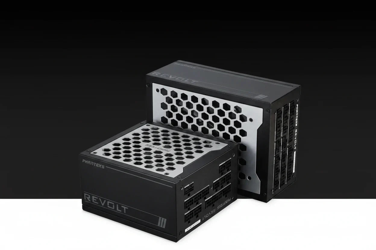 Two PC power supplies from the REVOLT series, one by PHINTEK48 in the foreground and one by ASRock in the background, shown on a black-to-white gradient studio background.